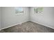 This cozy bedroom features neutral walls, plush carpet, and natural light from two windows at 2853 S State Ave, Indianapolis, IN 46203