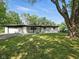 Charming one-story home with a well-manicured lawn and mature trees, creating a welcoming curb appeal at 2853 S State Ave, Indianapolis, IN 46203
