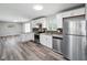 Modern kitchen featuring stainless steel appliances, granite countertops, and ample cabinet space at 2853 S State Ave, Indianapolis, IN 46203
