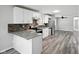 Bright kitchen features stainless steel appliances, granite countertops, white cabinets, and mosaic backsplash at 2853 S State Ave, Indianapolis, IN 46203