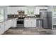 Stylish kitchen featuring stainless steel appliances, granite countertops, and a mosaic backsplash at 2853 S State Ave, Indianapolis, IN 46203