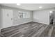 Bright living room showcasing stylish flooring, fresh paint, and an entrance to the bath, creating a modern atmosphere at 2853 S State Ave, Indianapolis, IN 46203