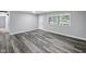 Living room featuring new flooring, neutral walls, and a bright window offering an airy atmosphere at 2853 S State Ave, Indianapolis, IN 46203