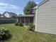Spacious backyard featuring an enclosed sunroom, a lush lawn, and mature landscaping at 2929 Tuscarora Ln, Indianapolis, IN 46217