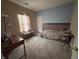 Cozy bedroom with neutral carpet, a window that allows for lots of natural light and warm, inviting atmosphere at 2929 Tuscarora Ln, Indianapolis, IN 46217