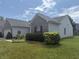 Exterior view showcasing the house siding, trimmed shrubbery, and green grass at 2929 Tuscarora Ln, Indianapolis, IN 46217