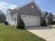Exterior shot showcasing two car garage with white garage door, next to a well maintained lawn at 2929 Tuscarora Ln, Indianapolis, IN 46217