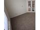 Spacious living room featuring neutral carpet flooring and french doors at 2929 Tuscarora Ln, Indianapolis, IN 46217