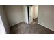 Bedroom with carpet flooring and a view of hallway with wood floors at 3302 N Butler Ave, Indianapolis, IN 46218