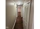Hallway with wood flooring, closet, and neutral colored walls at 3302 N Butler Ave, Indianapolis, IN 46218