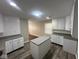 Bright kitchen with white cabinets, granite countertops and an island at 3302 N Butler Ave, Indianapolis, IN 46218