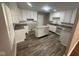 Well-lit kitchen with white cabinets, granite countertops and a stylish island at 3302 N Butler Ave, Indianapolis, IN 46218