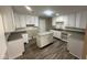 Well-lit kitchen with white cabinets, granite countertops and a stylish island at 3302 N Butler Ave, Indianapolis, IN 46218