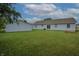 Spacious backyard with a large lawn, slider to the home and an adjacent detached garage at 3350 Cessna Dr, Columbus, IN 47203