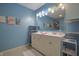 Stylish bathroom with double sinks, a large mirror, and blue accent wall at 3350 Cessna Dr, Columbus, IN 47203