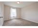 Cozy bedroom with neutral carpeting, large window, and soft natural light, creating a tranquil atmosphere at 3350 Cessna Dr, Columbus, IN 47203