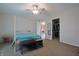 Spacious bedroom featuring a four-poster bed, ceiling fan, walk-in closet, and neutral carpet at 3350 Cessna Dr, Columbus, IN 47203