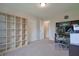 Well-lit bedroom featuring a large open shelving unit and carpeted floors, ideal for storage and comfort at 3350 Cessna Dr, Columbus, IN 47203