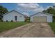 Charming light blue home with a separate garage and a well-maintained lawn at 3350 Cessna Dr, Columbus, IN 47203