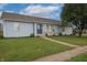 Charming one-story home featuring light blue siding, a well-manicured lawn, and a welcoming front entrance at 3350 Cessna Dr, Columbus, IN 47203
