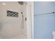Modern tiled shower featuring white tile and a rainfall shower head at 3350 Cessna Dr, Columbus, IN 47203