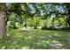 Large backyard with mature trees providing shade, perfect for outdoor activities and relaxation at 3609 N Keystone Ave, Indianapolis, IN 46218