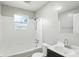 Cozy bathroom with shower-tub combo, vanity with storage, and white tile at 3609 N Keystone Ave, Indianapolis, IN 46218