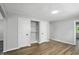 Bedroom with wood floors, two closets, and an open doorway to another room at 3609 N Keystone Ave, Indianapolis, IN 46218