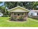 Inviting bungalow with a covered porch, manicured bushes, and a well-kept lawn at 3609 N Keystone Ave, Indianapolis, IN 46218