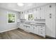 Well-lit kitchen with white cabinets, granite countertops, and a double sink under a window at 3609 N Keystone Ave, Indianapolis, IN 46218