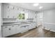 Bright kitchen with white cabinets, a stainless steel sink, and modern countertops at 3609 N Keystone Ave, Indianapolis, IN 46218