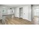 Open living space featuring wood floors, closets, and view into the bathroom at 3609 N Keystone Ave, Indianapolis, IN 46218