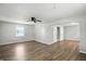 Bright living room with wood floors, a ceiling fan, and an open doorway to another room at 3609 N Keystone Ave, Indianapolis, IN 46218