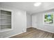 Living room features beautiful wood-look floors and a built-in shelving unit at 3609 N Keystone Ave, Indianapolis, IN 46218