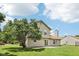 Exterior backyard view of a two-story home with lush green grass and mature trees at 373 Austin Dr, Avon, IN 46123