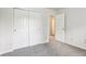 Neutral bedroom with closet, plush carpet, and an entry door bathed in natural light at 373 Austin Dr, Avon, IN 46123