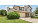 Two-story home features a brick facade, neutral siding, attached garage, and well-maintained lawn at 373 Austin Dr, Avon, IN 46123