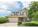 Charming two-story home features a brick facade, green shutters, and well-maintained landscaping at 373 Austin Dr, Avon, IN 46123