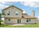 Back exterior of a two-story house with neutral siding, windows, and a sliding glass door leading to a patio at 373 Austin Dr, Avon, IN 46123