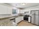 Bright kitchen features granite counters, stainless steel appliances, and white cabinets at 373 Austin Dr, Avon, IN 46123