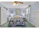 Bright bedroom with ceiling fan, window, and stylish comforter and pillows at 38 W Main St, Brownsburg, IN 46112