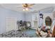 Bedroom featuring a ceiling fan, window, and closet doors; contents of the room are in disarray at 38 W Main St, Brownsburg, IN 46112
