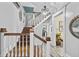 A staircase with wooden steps and white spindles, complemented by modern lighting at 38 W Main St, Brownsburg, IN 46112