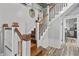 The wooden staircase with white railings leads to the upper levels of this home at 38 W Main St, Brownsburg, IN 46112