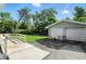 Backyard featuring a detached garage, lawn, and wooden deck at 4023 N Arlington Ave, Indianapolis, IN 46226