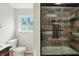 Modern bathroom with tiled shower, glass door, and elegant vanity at 4023 N Arlington Ave, Indianapolis, IN 46226