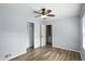 This bedroom has wood floors, a ceiling fan and a closet with doors that lead to the bathroom at 4023 N Arlington Ave, Indianapolis, IN 46226