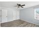 Neutral bedroom with hardwood floors, ceiling fan, closet, and window at 4023 N Arlington Ave, Indianapolis, IN 46226