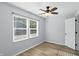Light-filled bedroom with hardwood floors, a ceiling fan, and a large window with a view at 4023 N Arlington Ave, Indianapolis, IN 46226