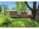 Attractive two-story home with a brick lower level, wood siding, and lush front yard at 4023 N Arlington Ave, Indianapolis, IN 46226
